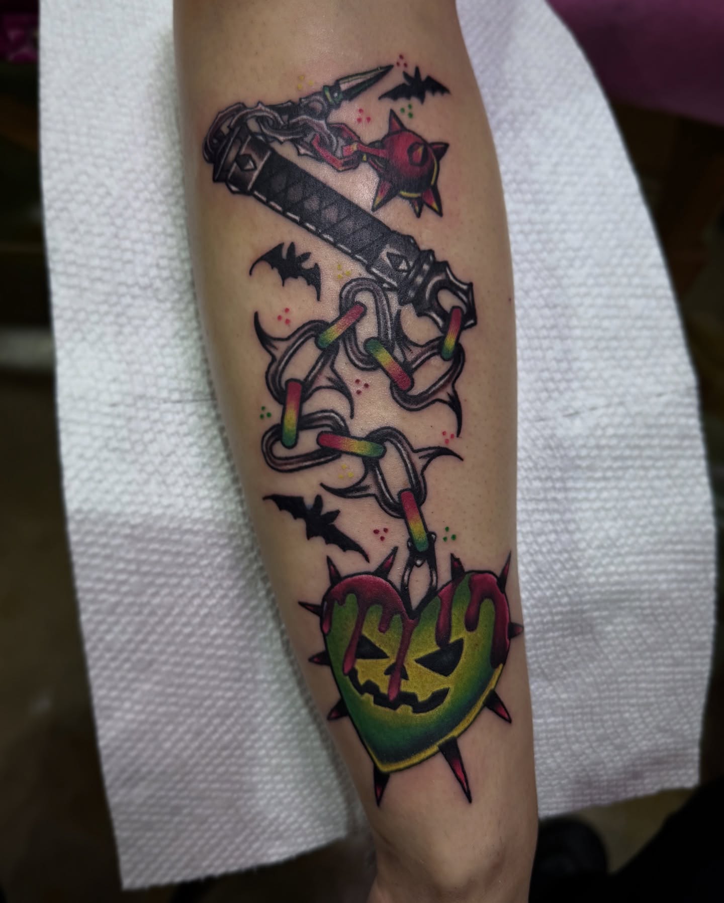 Chainsaw and heart neo-traditional tattoo on the forearm by Alexandra Fische