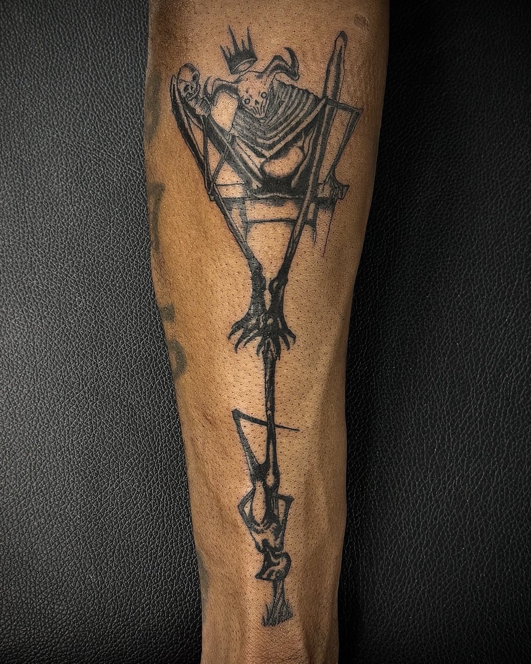 Skeleton in throne black and grey tattoo on the forearm by David