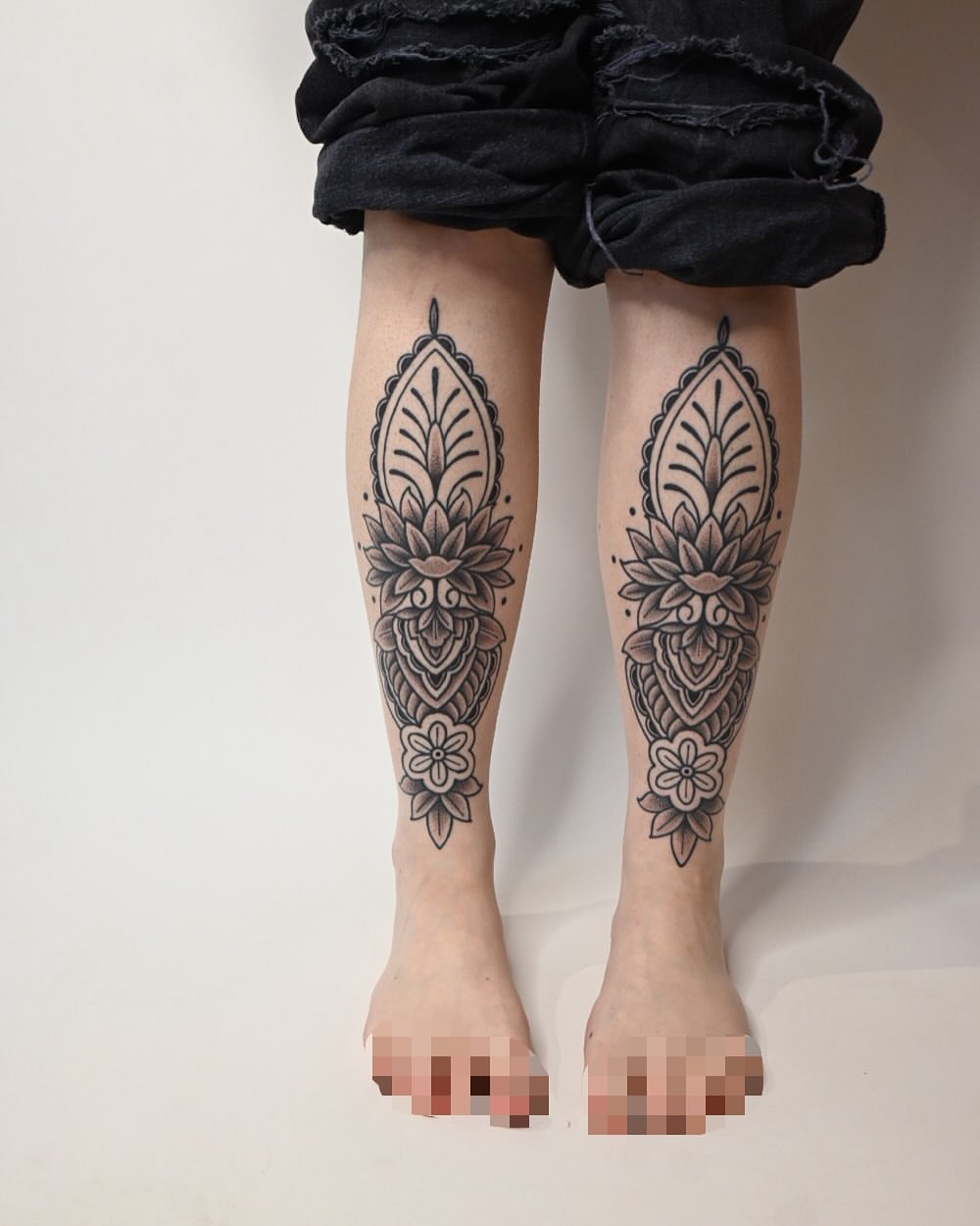 Floral mandala black and grey tattoo on the calf by Simba Nguyen