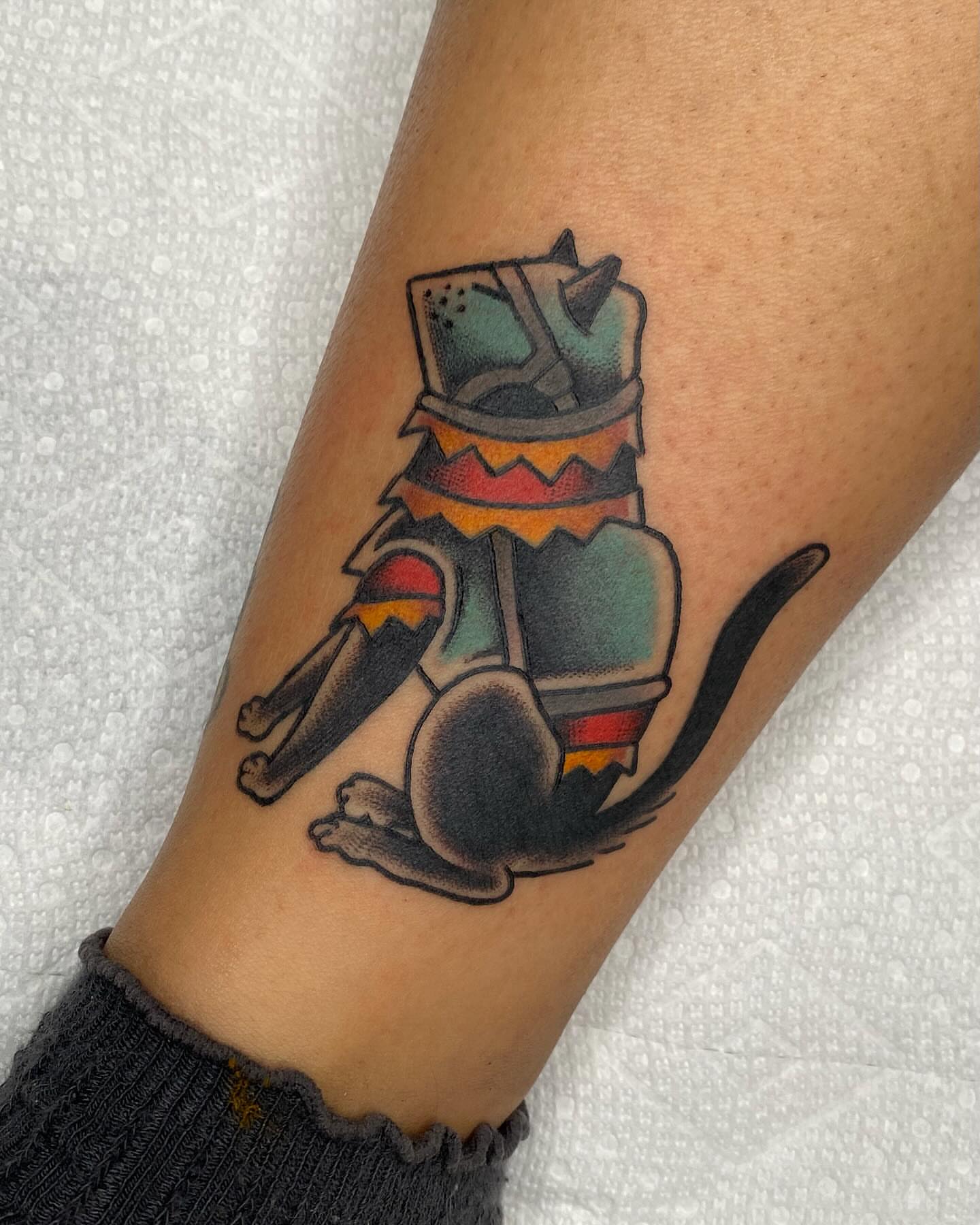 Cat wearing hat American traditional tattoo on the forearm by Morgana Sutherland
