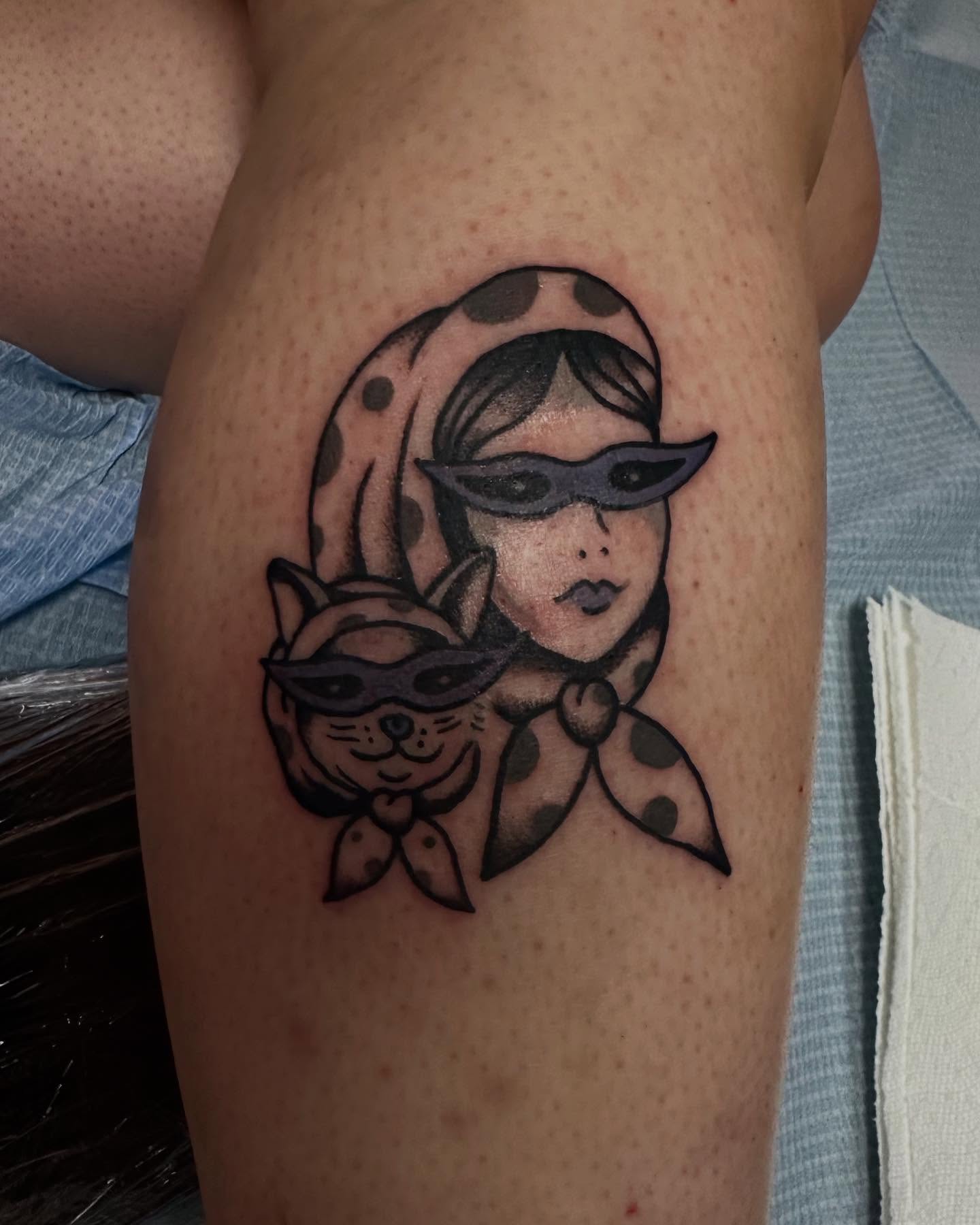 Cat and woman black and grey tattoo on the thigh by Olive Kelley