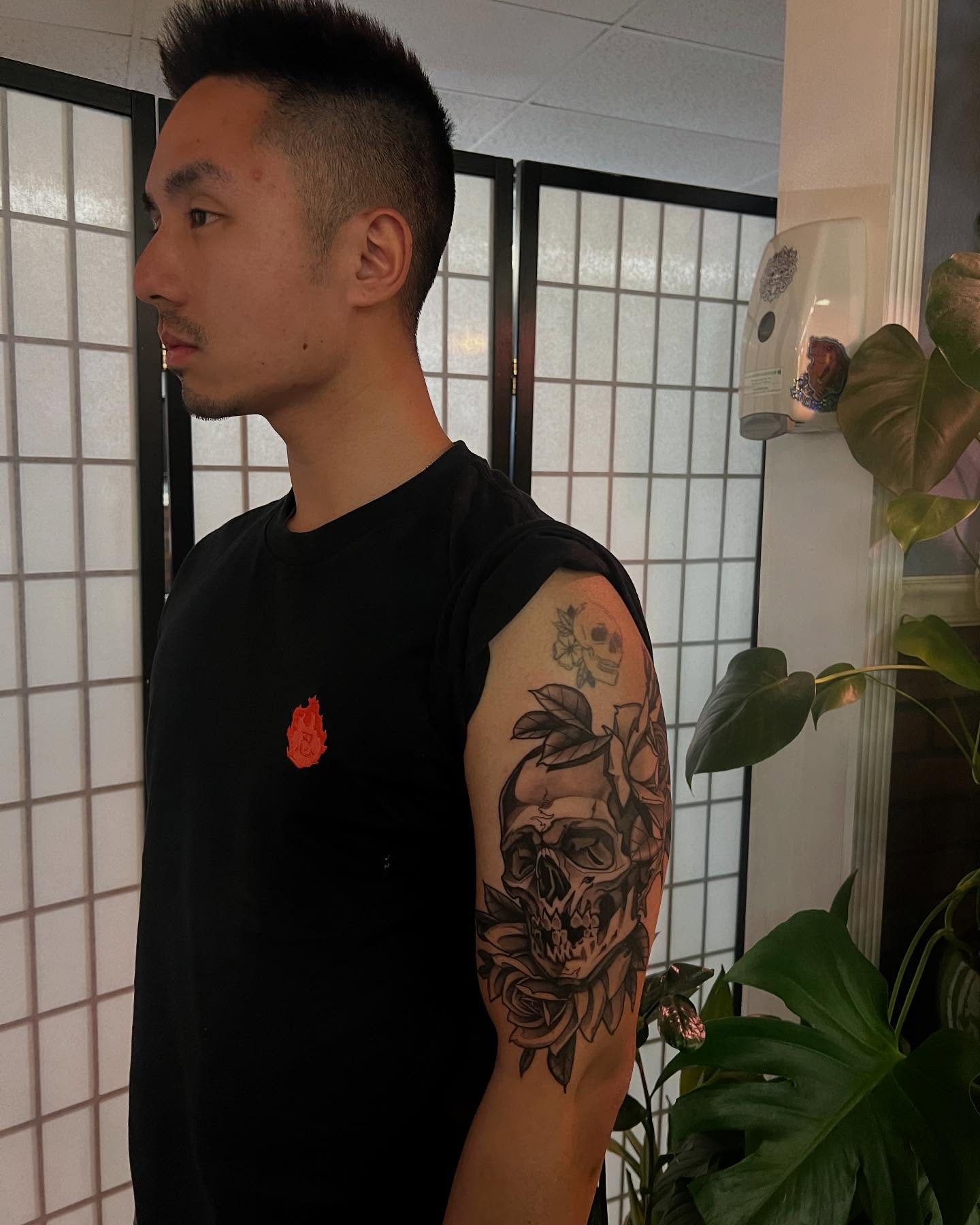 Skull and roses realism tattoo on the forearm by Neo-Traditional tattoos in Las Vegas
