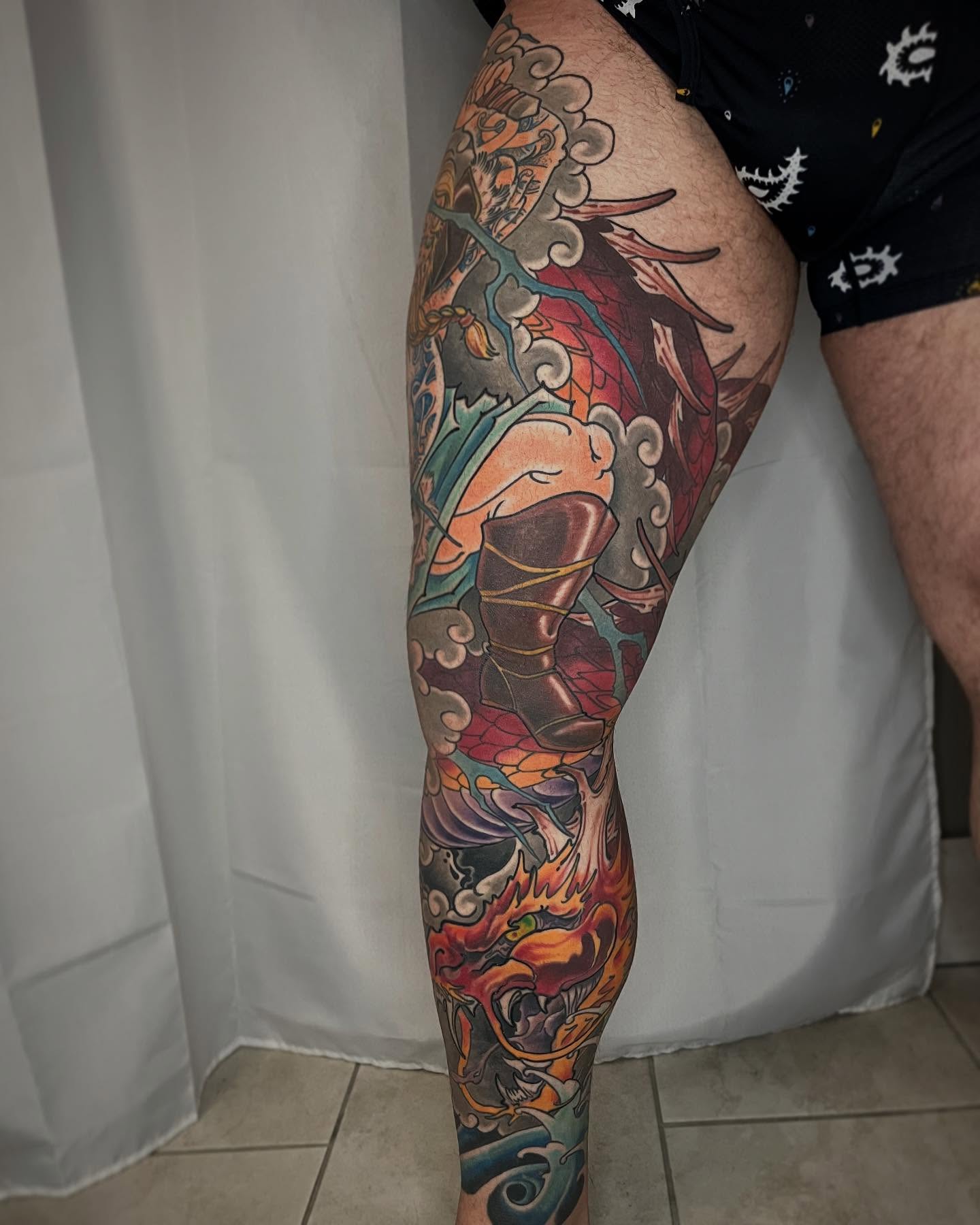 Warrior and dragon American traditional tattoo on the leg by biggstattoos