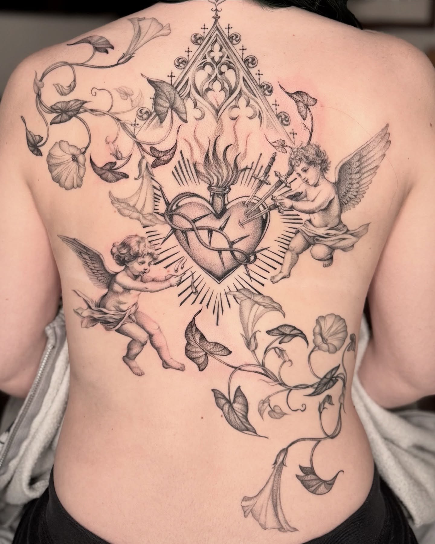Heart with cherubs neo-traditional tattoo on the back by Carla AKA Turnip girl