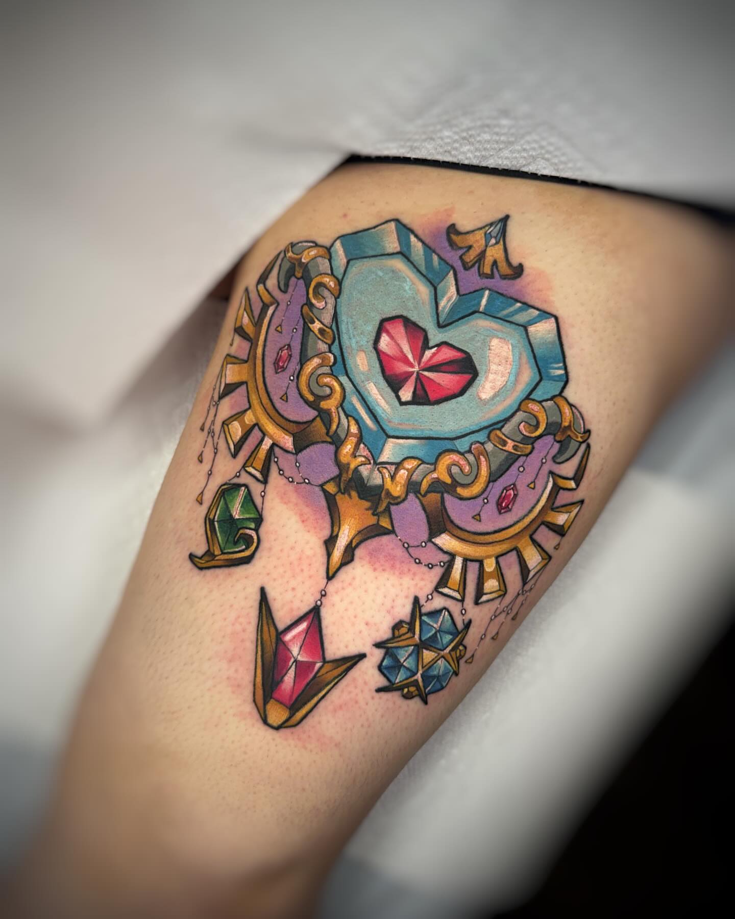 Gemstone and ornate frame geometric tattoo on the thigh by Anna Saveria