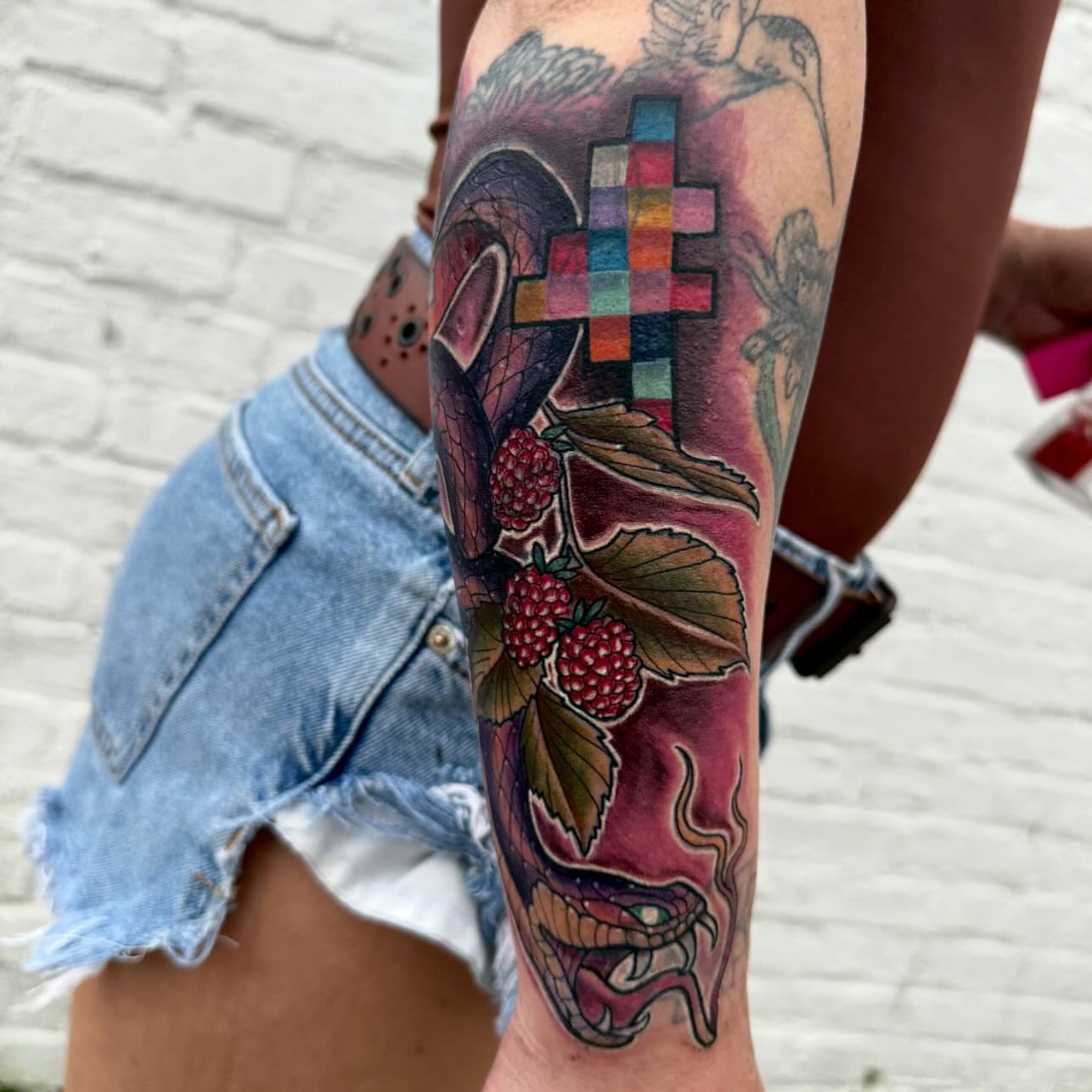 Raspberry snake geometric tattoo on the calf by Michael Latendresse