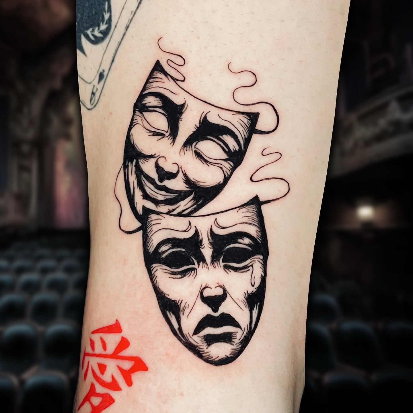 Theater masks realism tattoo on the forearm by Shontel Fowler