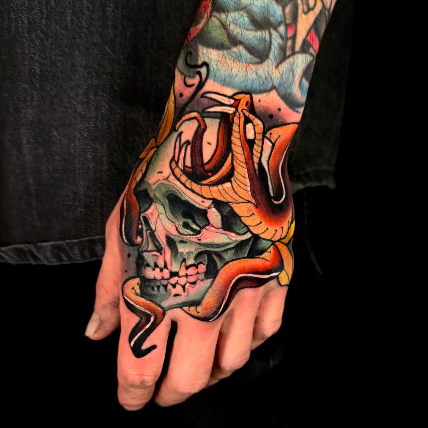 Skull with snake American traditional tattoo on the hand by Sweets, Nashville, Tennessee
