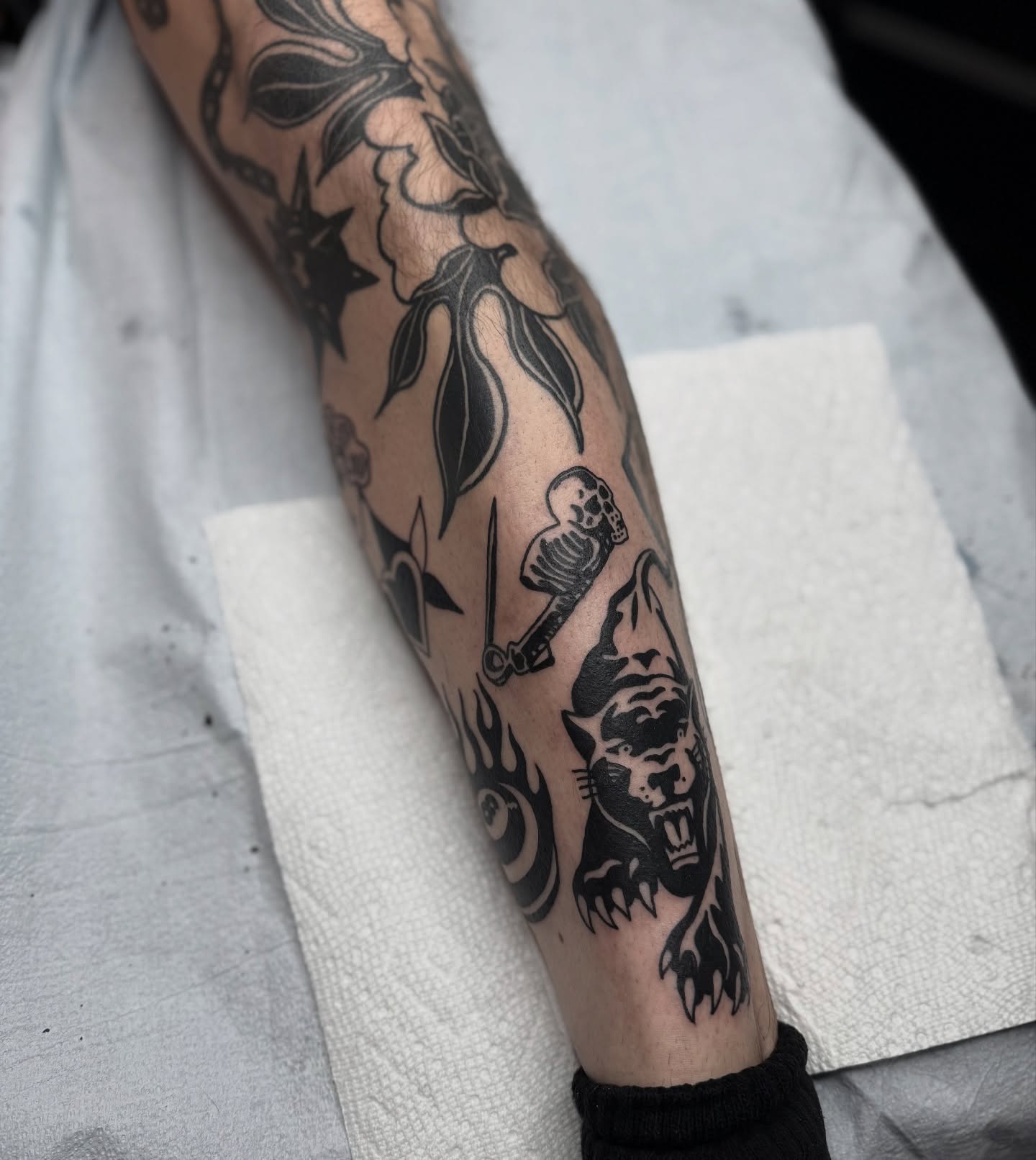 Panther and skull black and grey tattoo on the forearm by Han shinko, Portland, Oregon