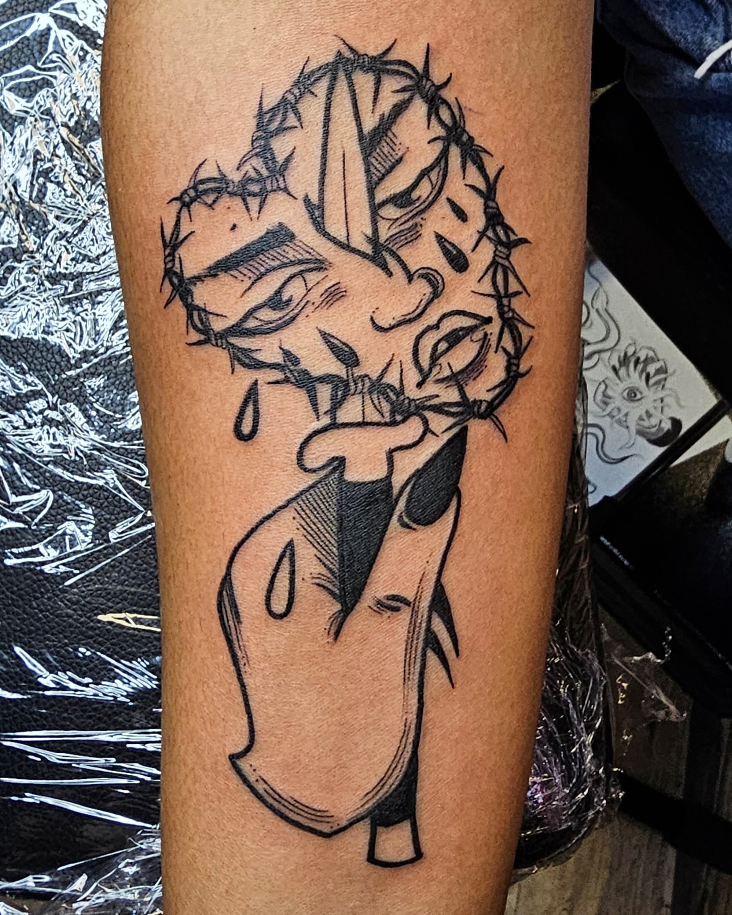 Barbed wire skull black and grey tattoo on the forearm by Ella Trick