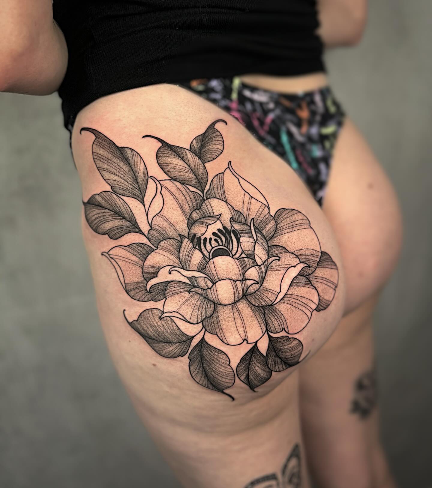 Flower black and grey tattoo on the thigh by Mallory Miller π³οΈβπ Eugene