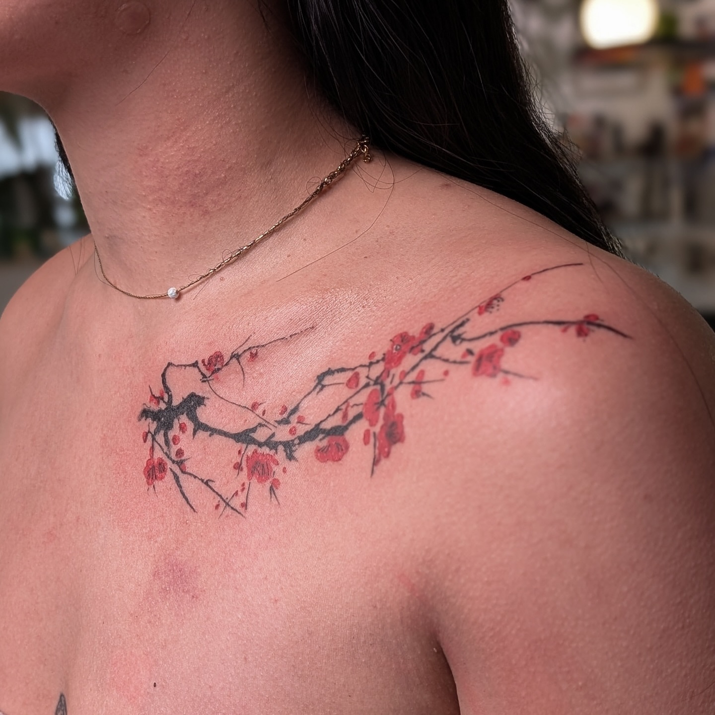 Cherry blossom branch dotwork tattoo on the shoulder by Jhenn