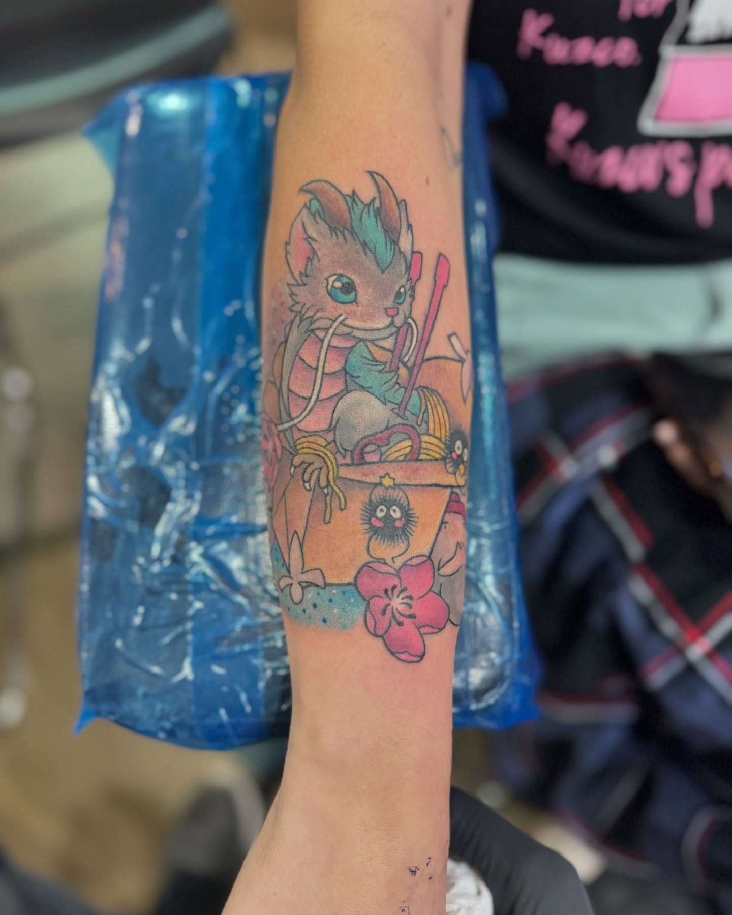 Cat and fruit basket anime tattoo on the forearm by Michael James, Bronx, New York