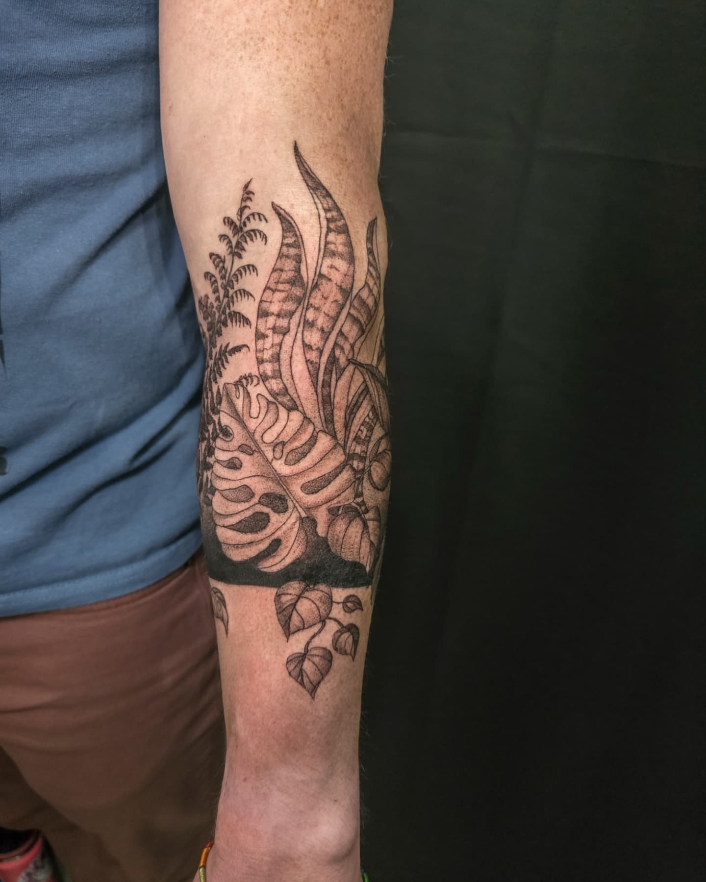Tropical leaves black and grey tattoo on the forearm by Utah Tattoo Artist