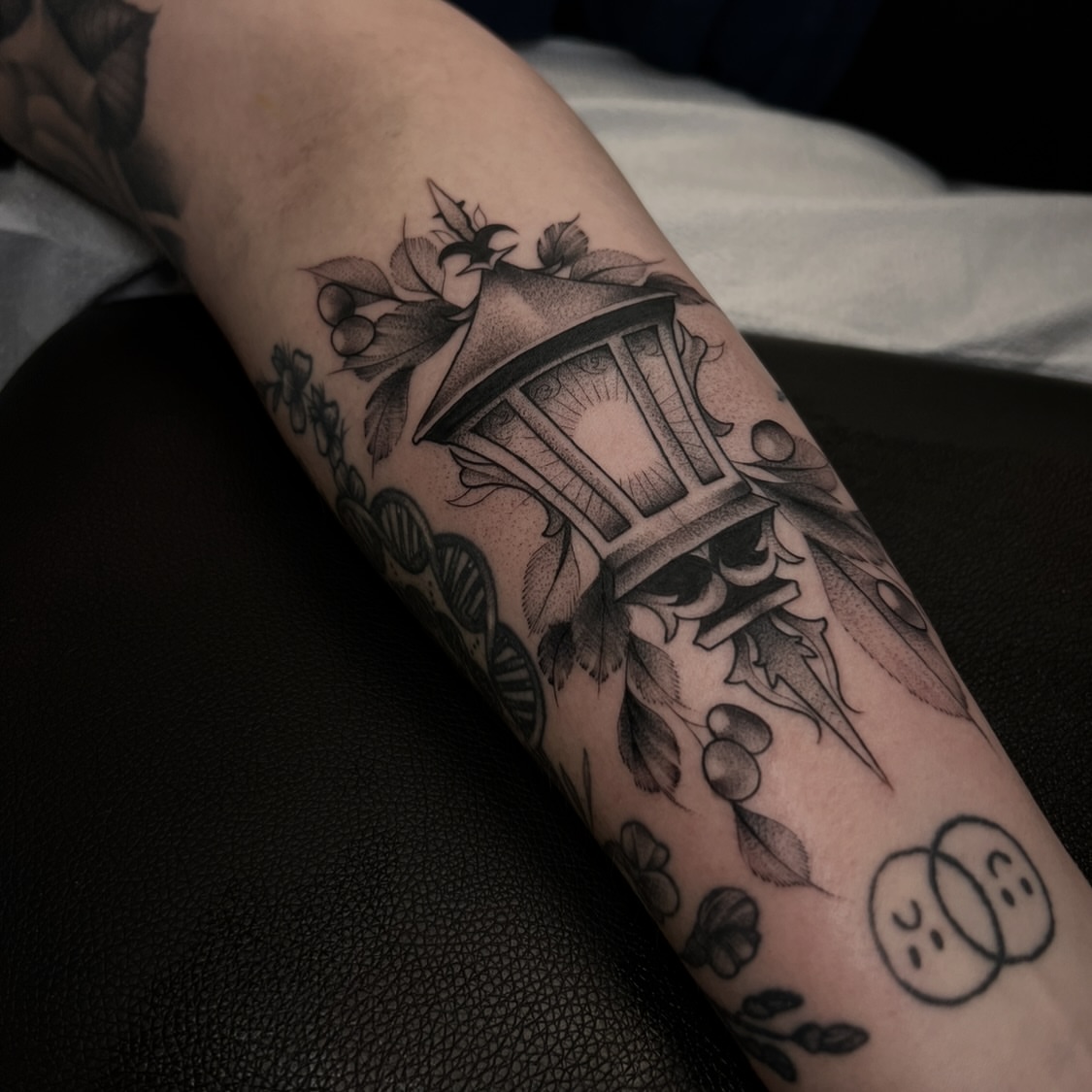 House and floral elements realism tattoo on the forearm by Chloe