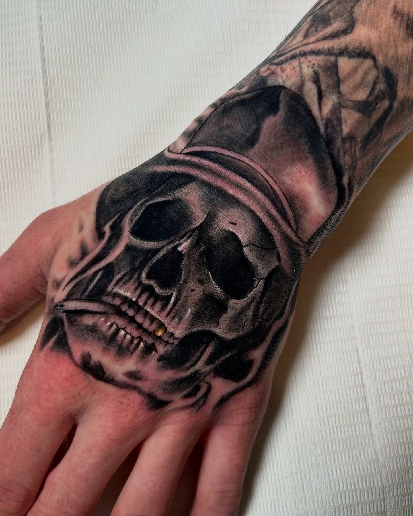 Skull dark realism tattoo on the hand by Tattoos By Lola Cavotta, Willoughby, Ohio