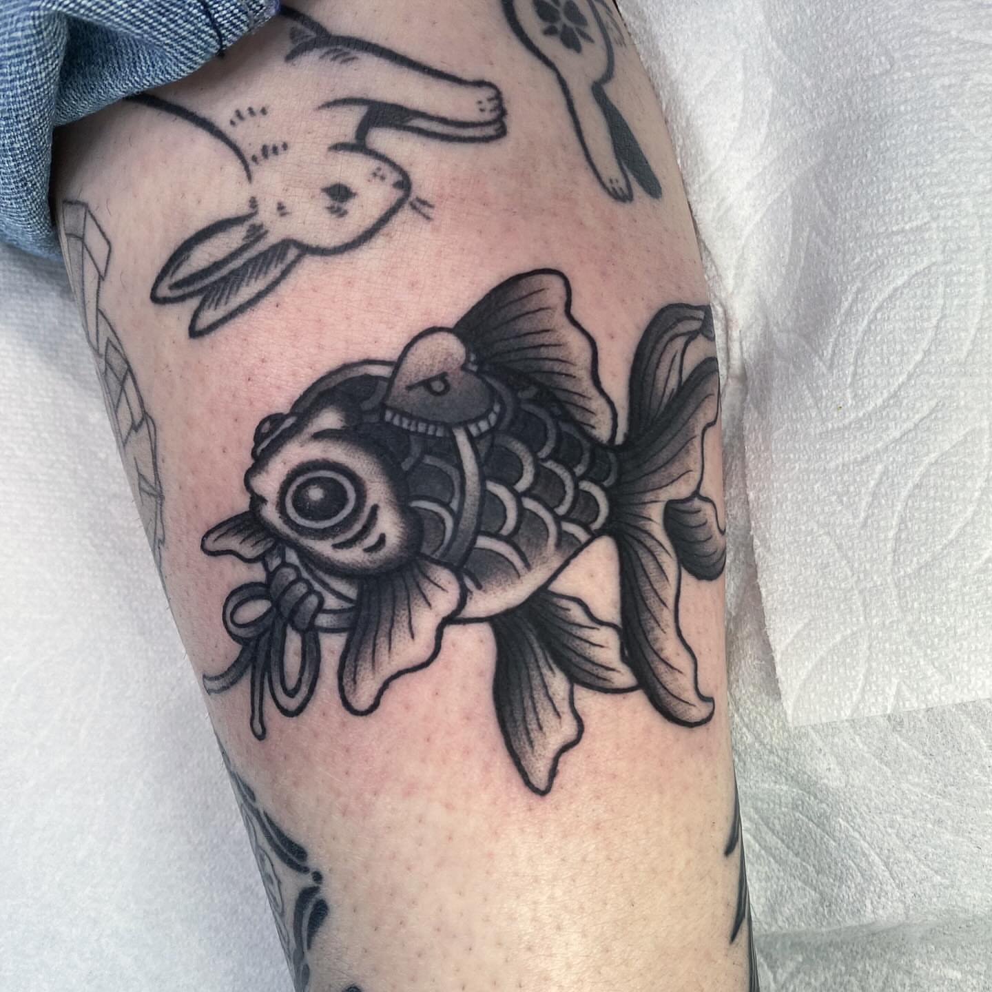 Koi fish black and grey tattoo on the forearm by Lindsey Cam Van