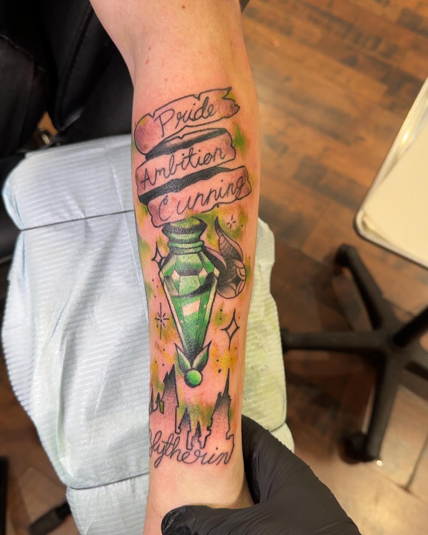 Lamp with banners watercolor tattoo on the forearm by Robbie Roberson