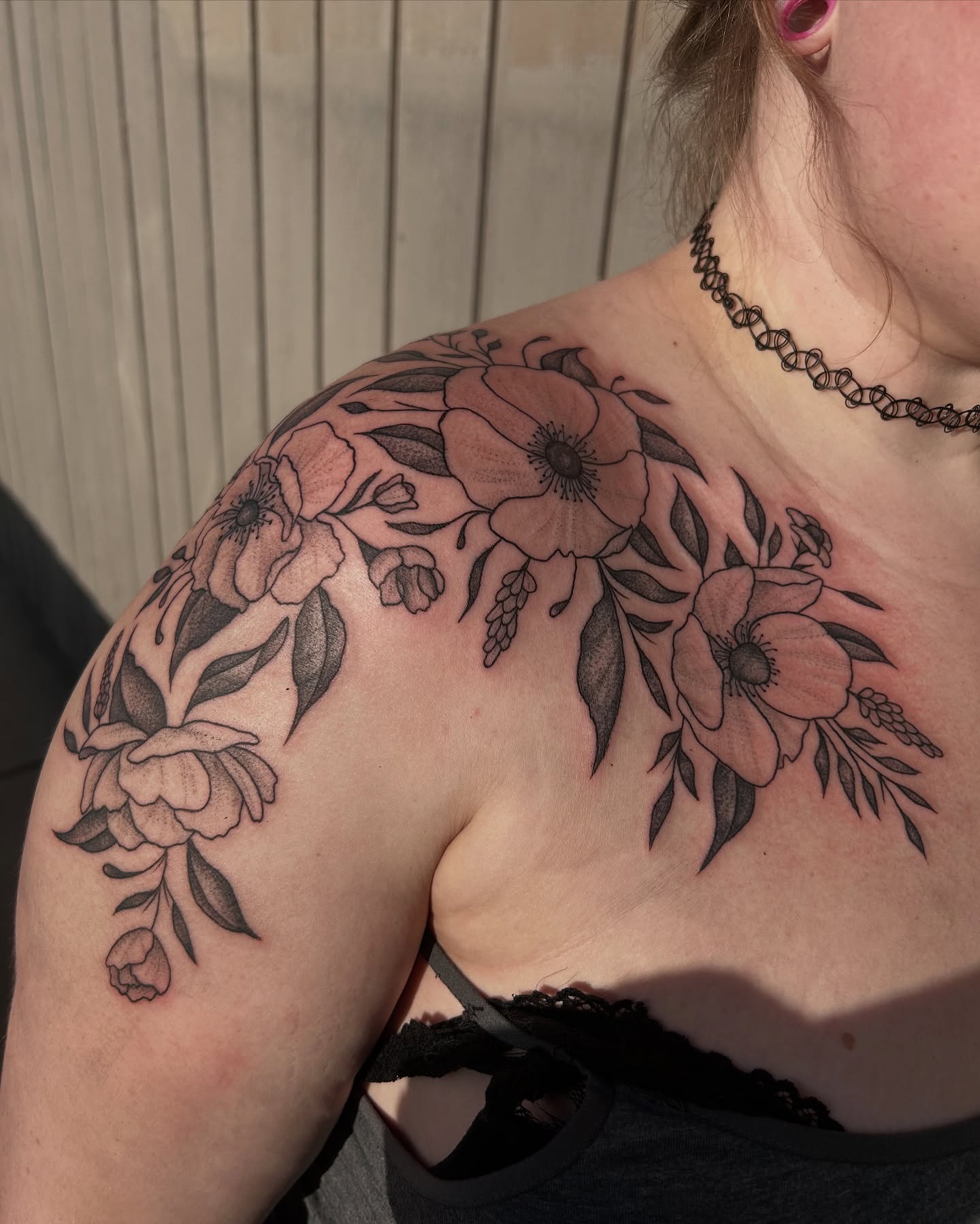 Floral arrangement black and grey tattoo on the shoulder by Vanessa Kendyll’s Tattoos