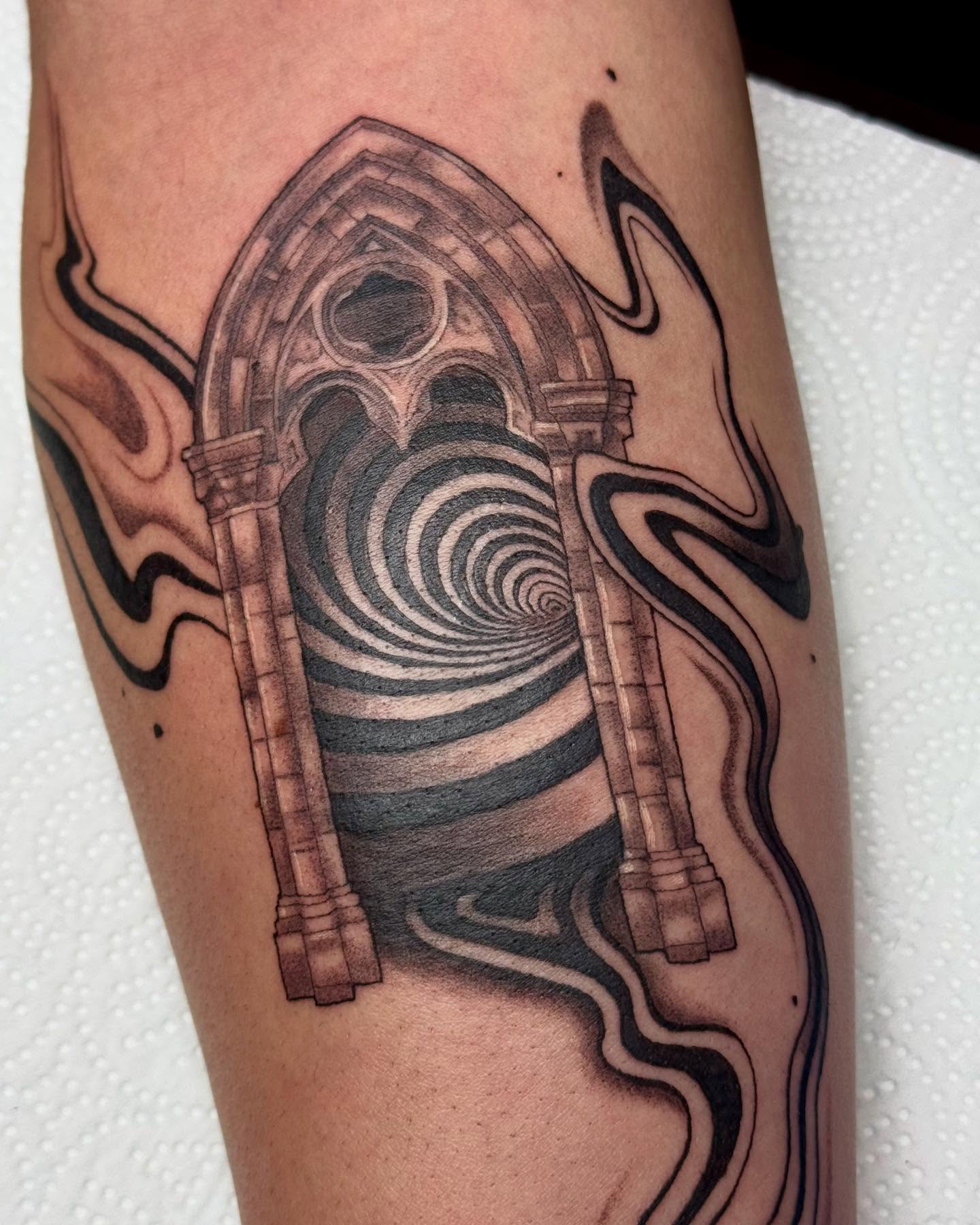 Archway with spiral surrealism tattoo on the forearm by Erin Blaney