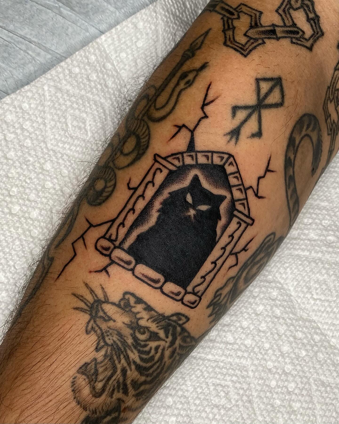 Star within shield black and grey tattoo on the forearm by Morgana Sutherland