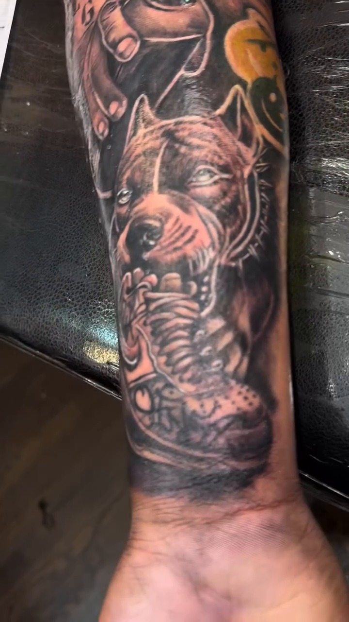 Pitbull and newspaper headline realism tattoo by Licensed Tattoo Artist πΈπ»