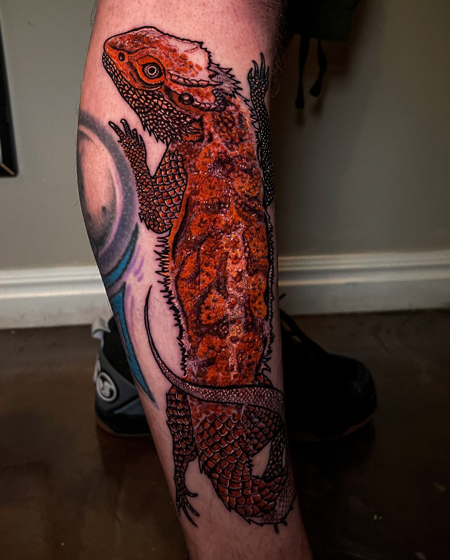Bearded dragon realism tattoo on the calf by Miguel Henrik