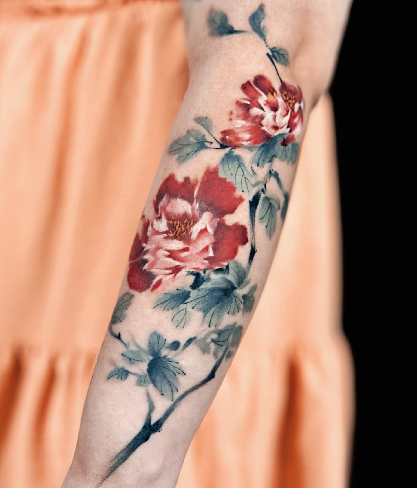 Peony flowers watercolor tattoo on the forearm by Abi