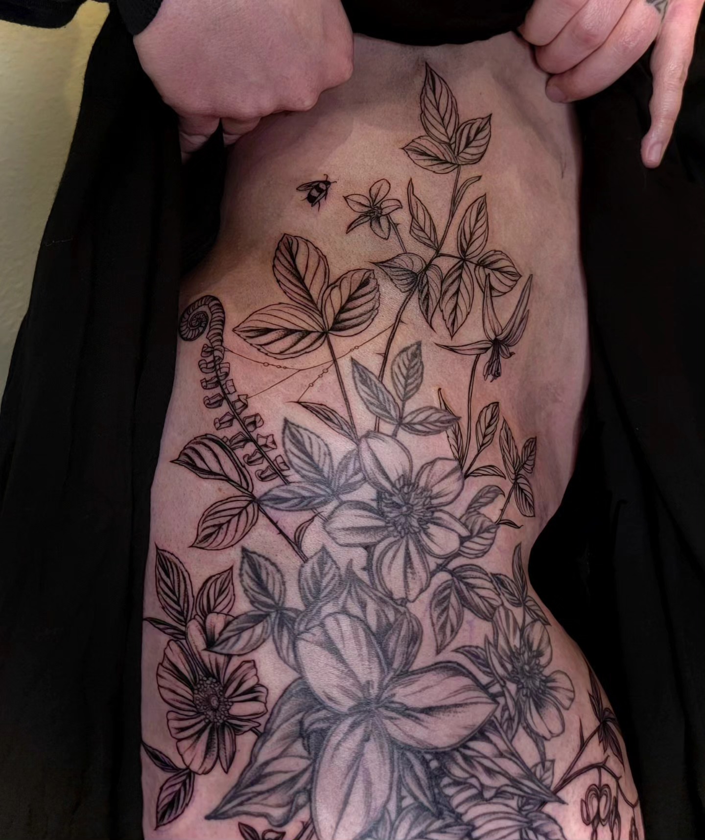 Botanical fine line tattoo on the thigh by Sierra (cc) Klein