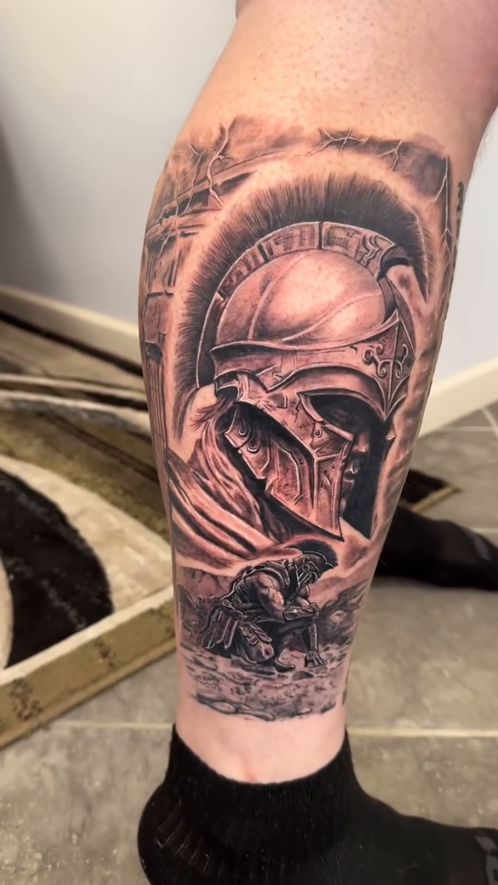 Spartan helmet and warrior realism tattoo on the calf by Juan Guzman
