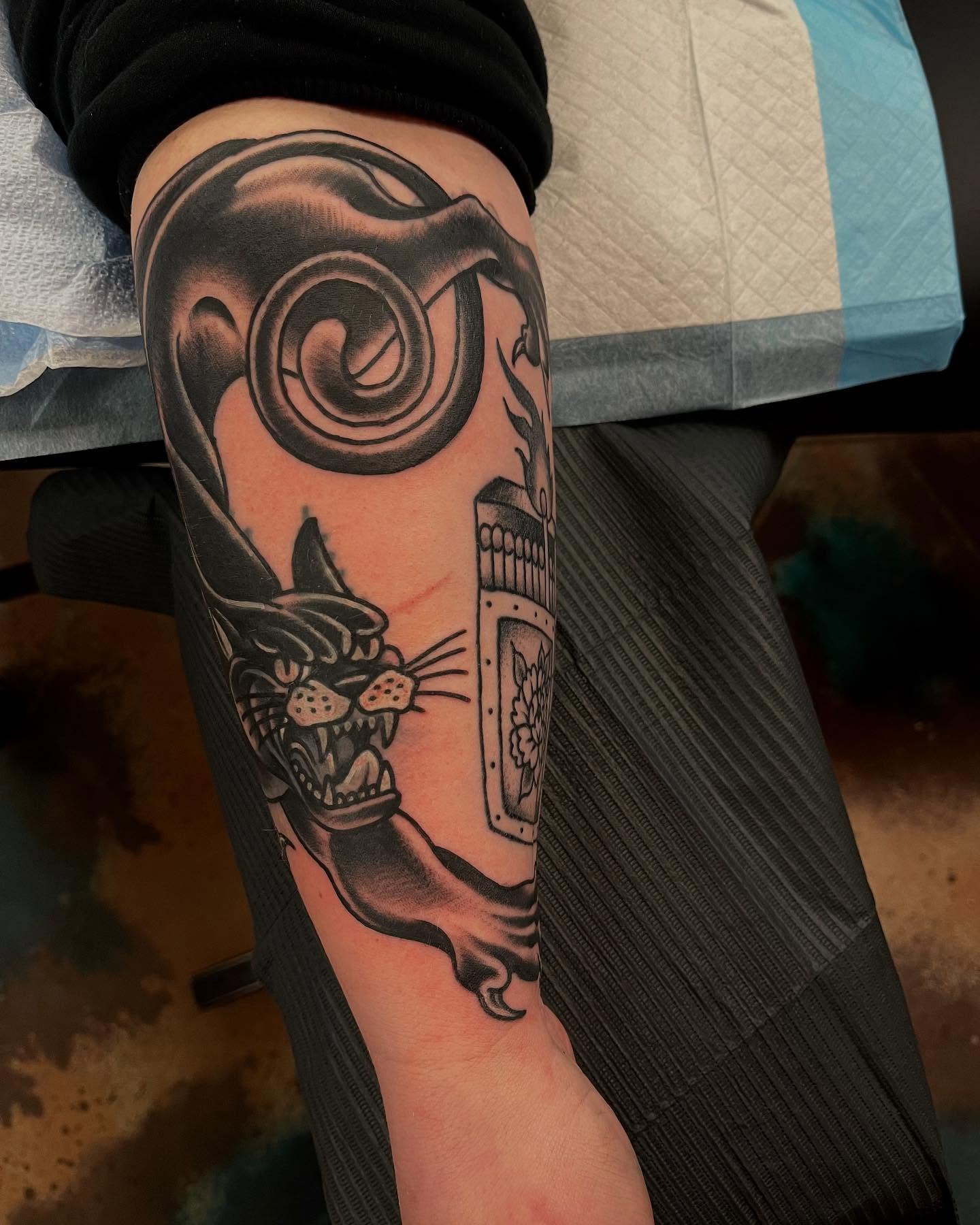 Panther and clock black and grey tattoo on the forearm by Lee Brewster, Erlanger, Kentucky