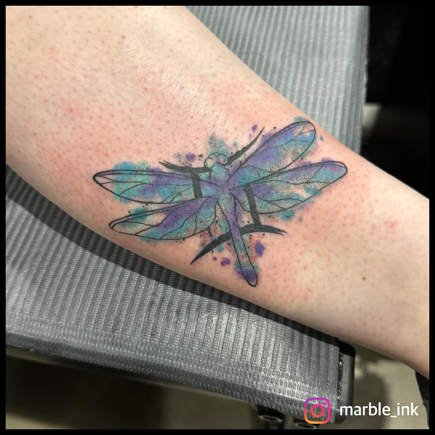 Dragonfly watercolor tattoo on the forearm by Darbi "Marbles"
