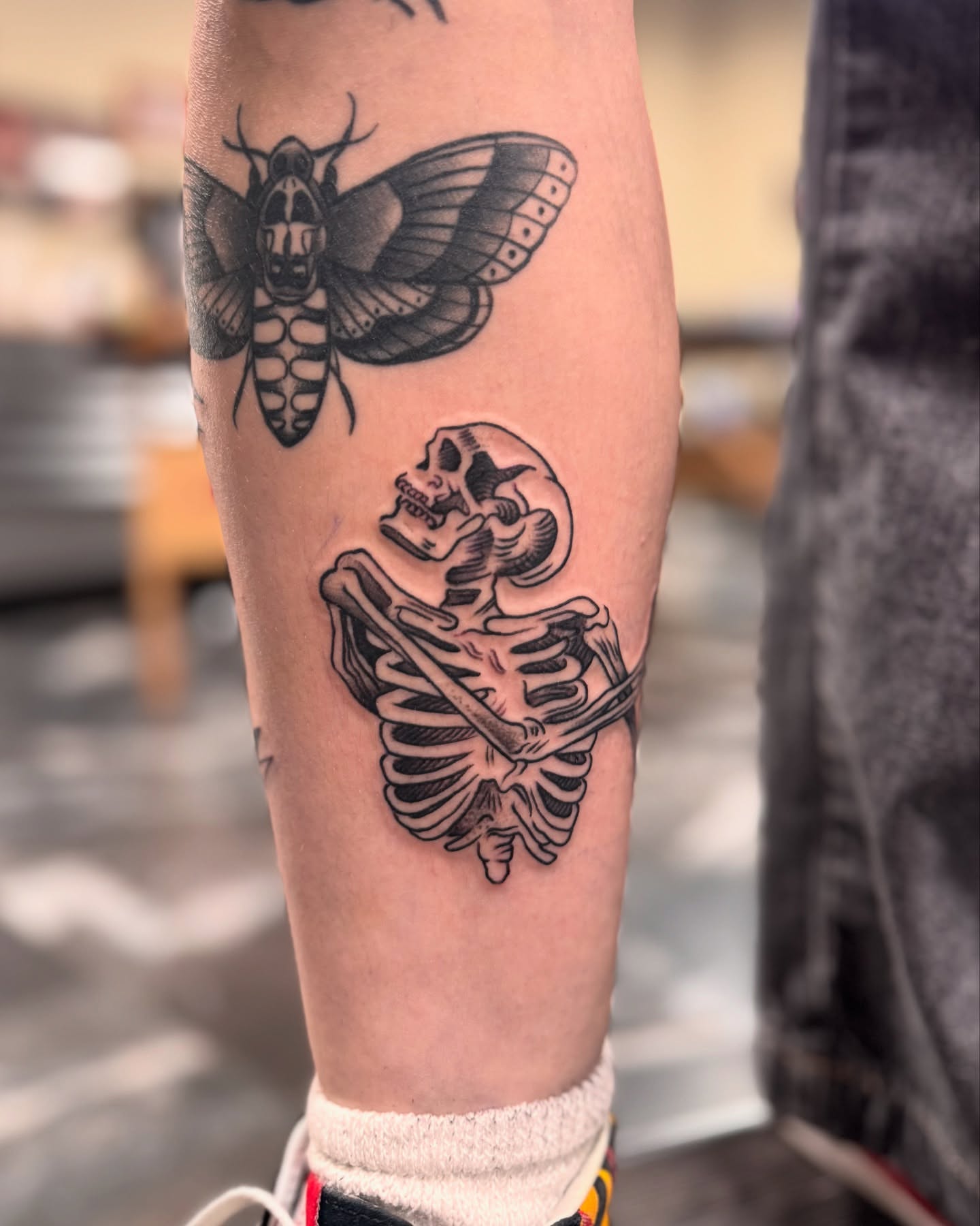 Skeleton black and grey tattoo on the forearm by Suda