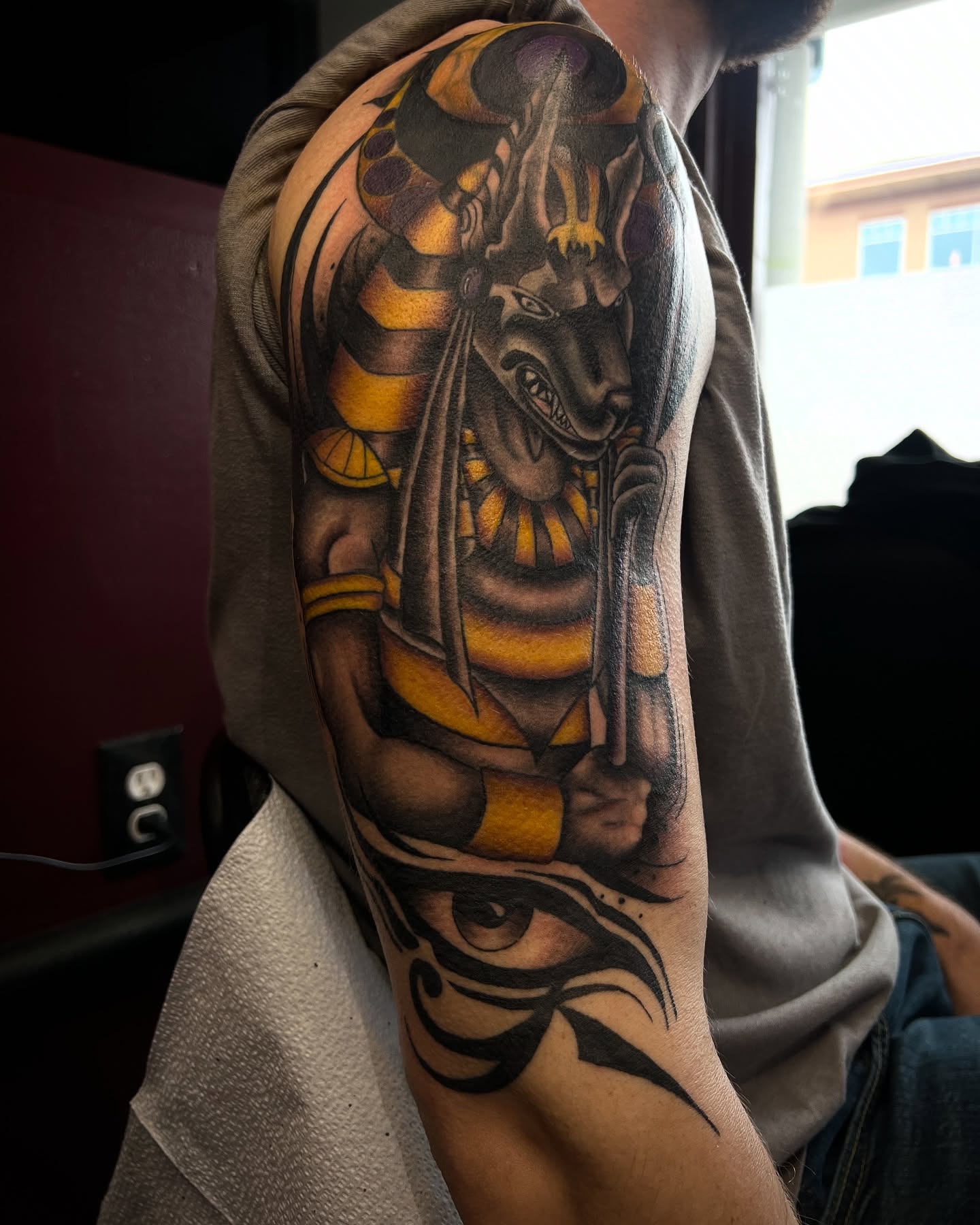 Ancient egyptian god realism tattoo on the upper arm by Stevie Reign