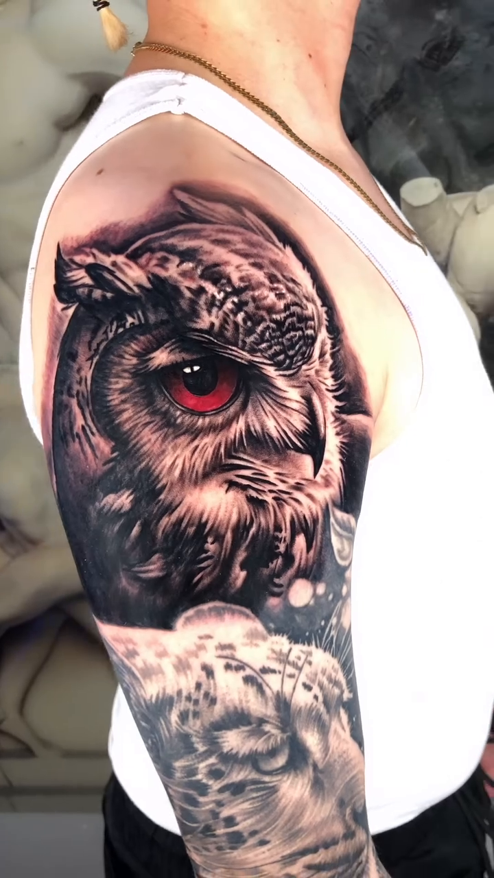 Owl and snow leopard realism tattoo by Danny Rodriguez