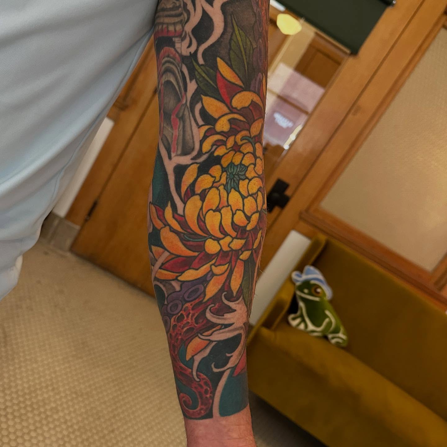 Chrysanthemum and deer American traditional tattoo on the forearm by Abigail Townsend