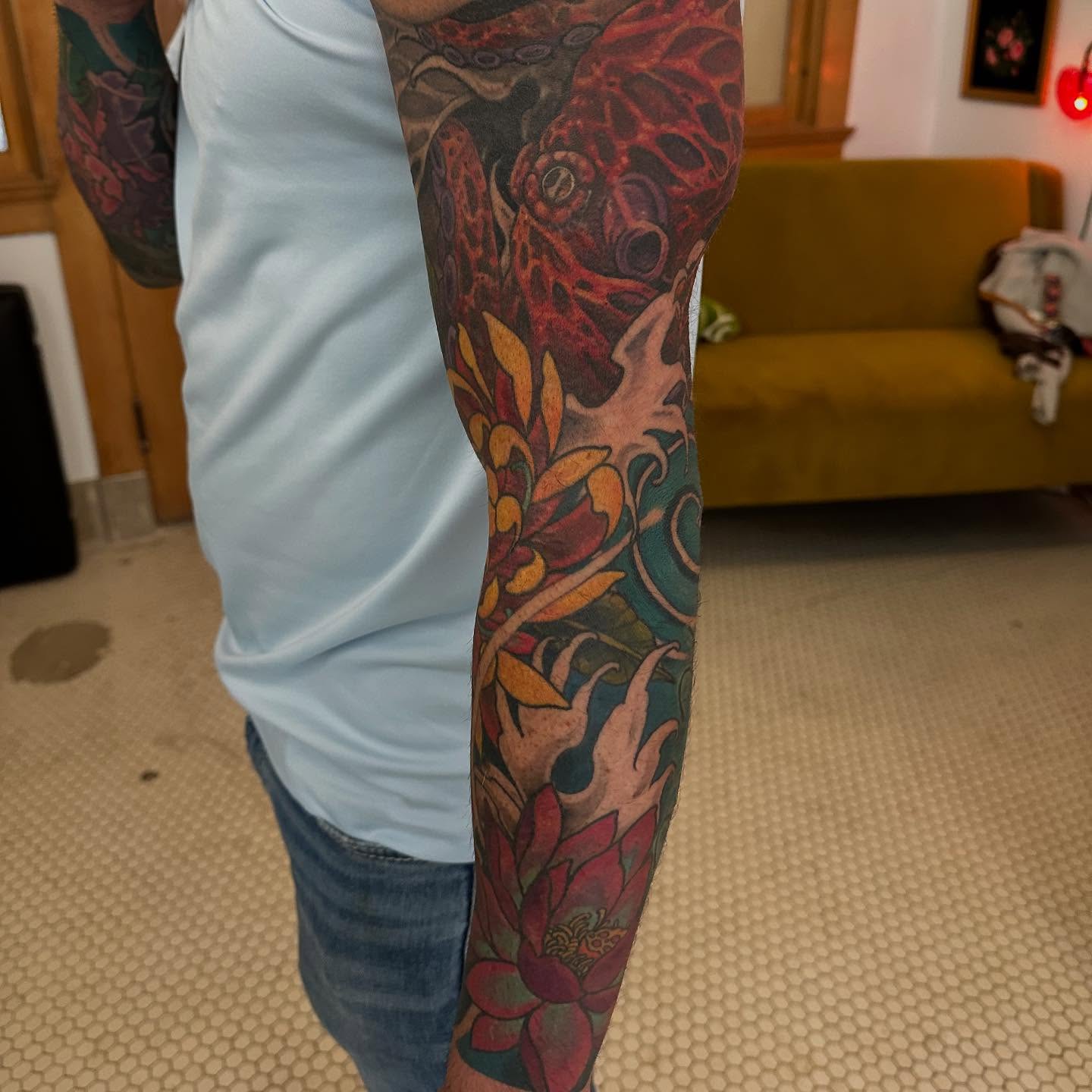Fish and floral japanese irezumi tattoo on the forearm by Abigail Townsend