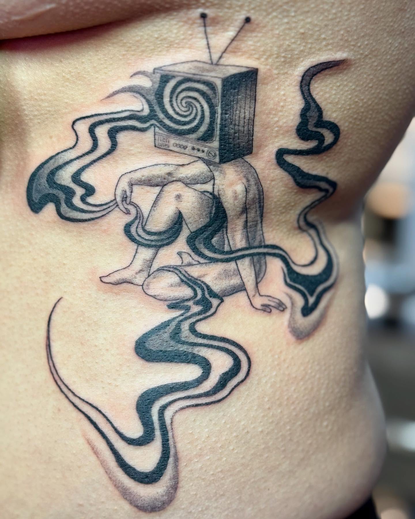 Tv-headed figure surrealism tattoo on the ribs by Erin Blaney