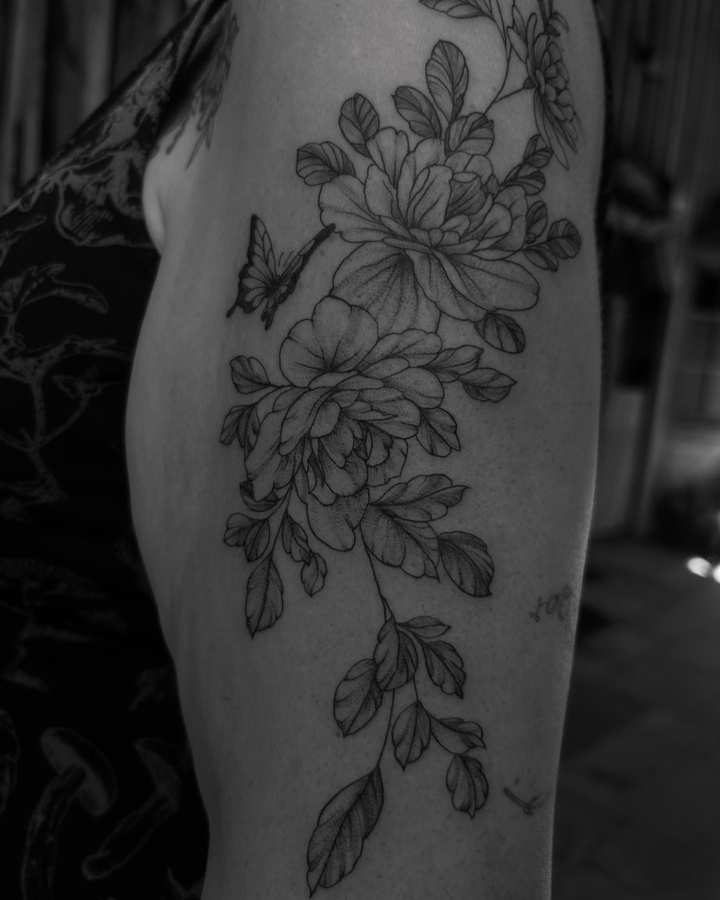 Floral arrangement black and grey tattoo on the thigh by Amara Lyons, Matakana, New Zealand