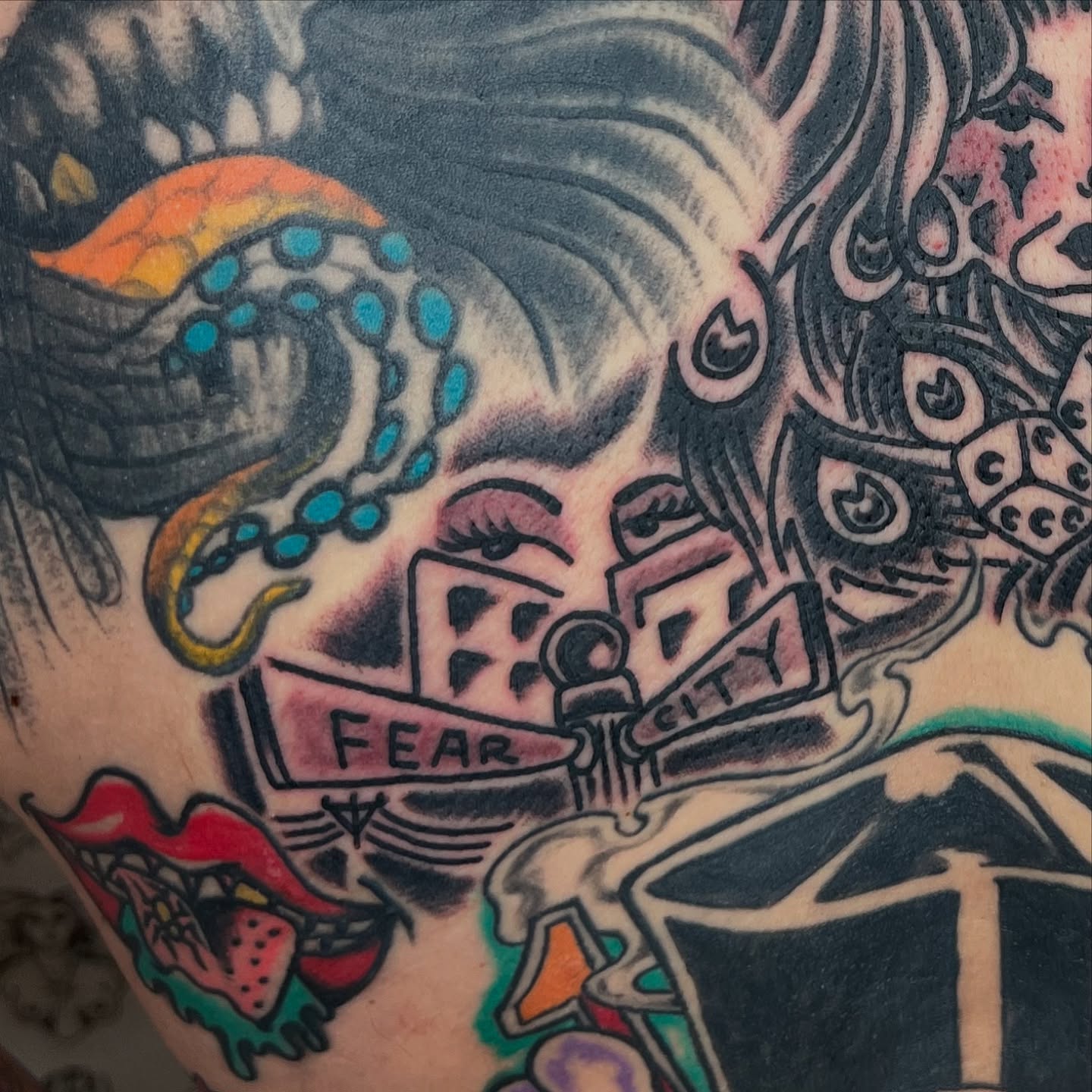 Woman with dice American traditional tattoo on the upper arm by Nestor Zelaya