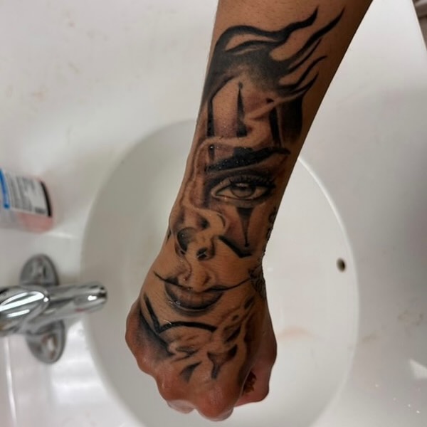 Face realism tattoo on the forearm by Koolz