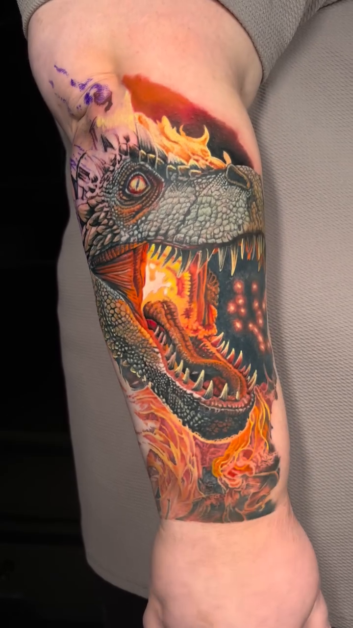Dinosaur head with fire realism tattoo by Jon Ronzka