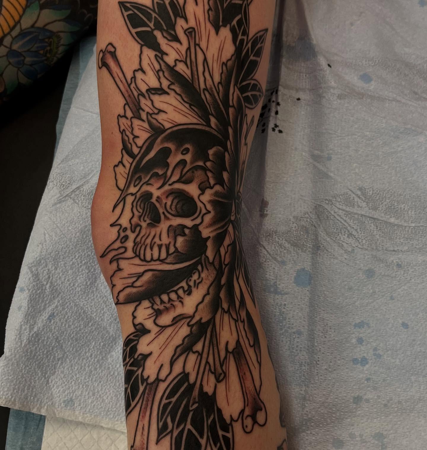Skull with floral crown realism tattoo on the forearm by Lee Brewster, Erlanger, Kentucky