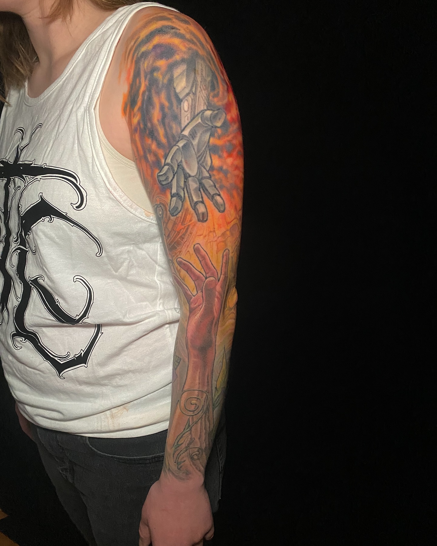Flame and hand realism tattoo on the upper arm by Jake Kirk