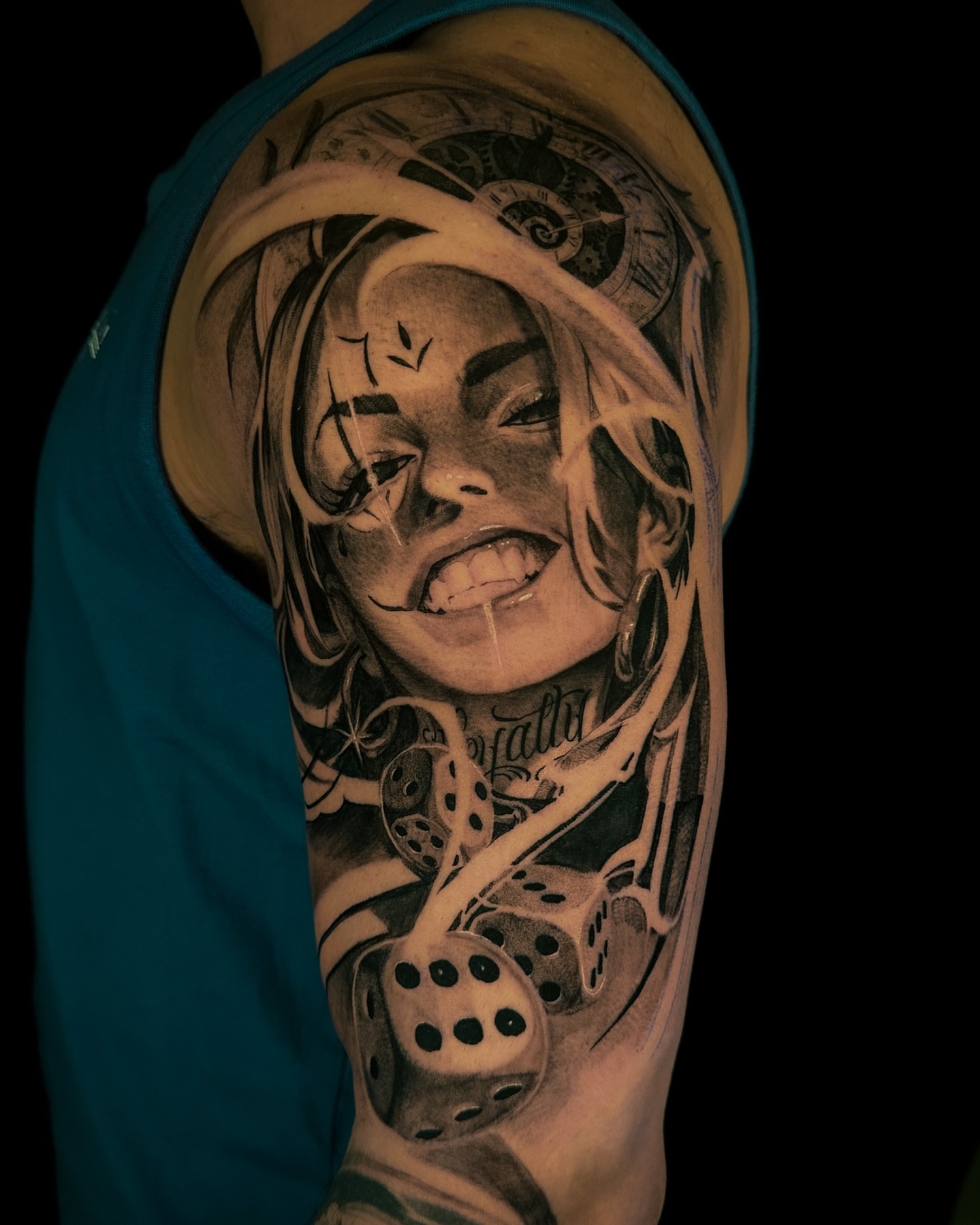 Woman with dice realism tattoo on the upper arm by Vince Lau