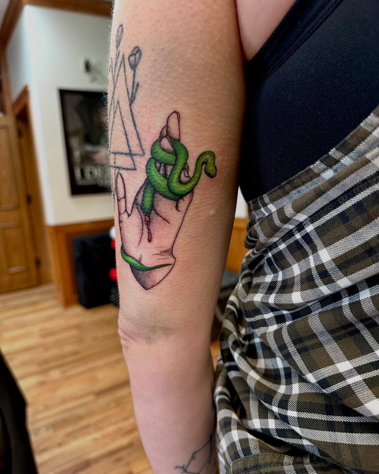 Snake and hand realism tattoo on the forearm by Marie Novotny, Lakewood, Ohio