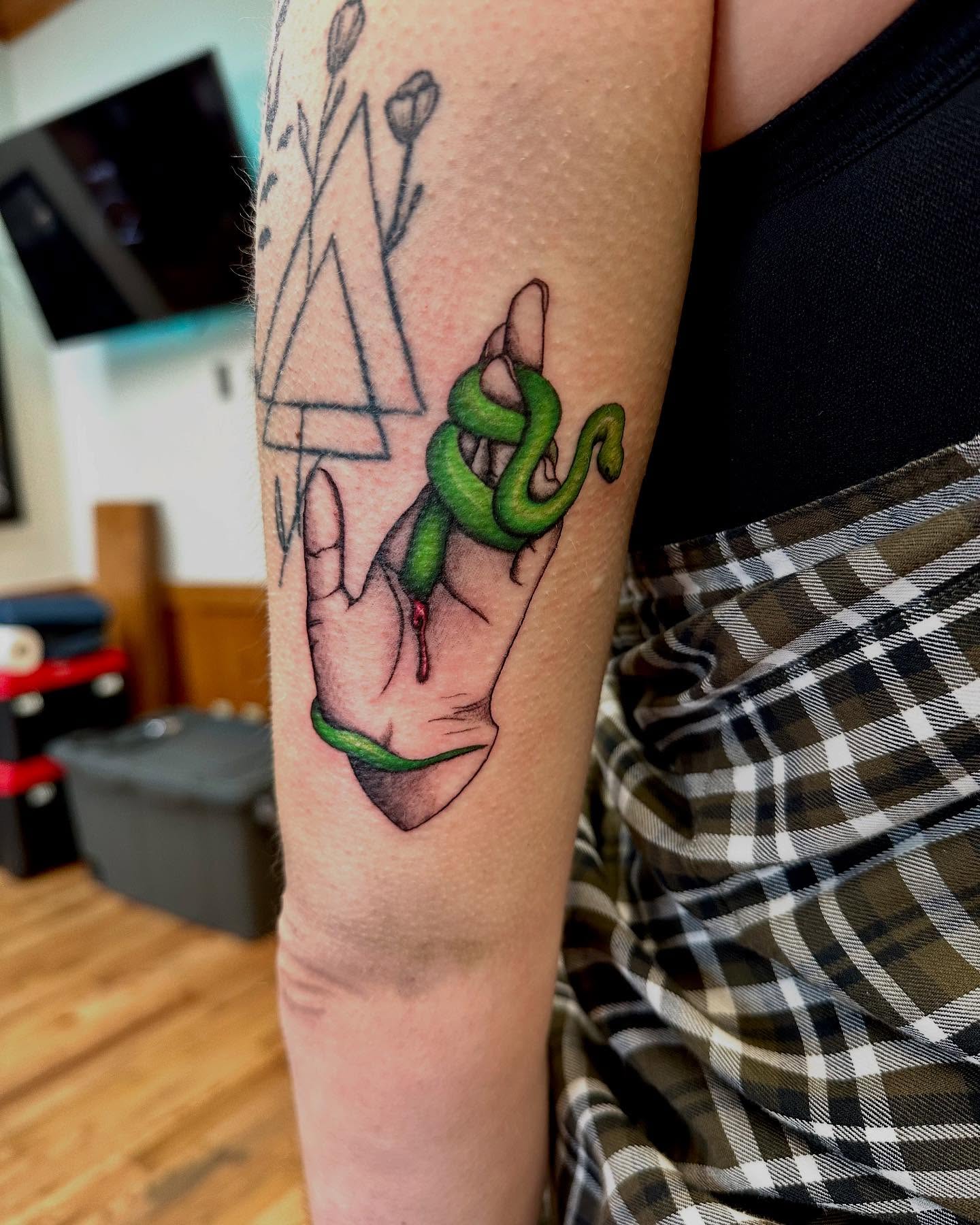 Snake and hand realism tattoo on the forearm by Marie Novotny, Lakewood, Ohio