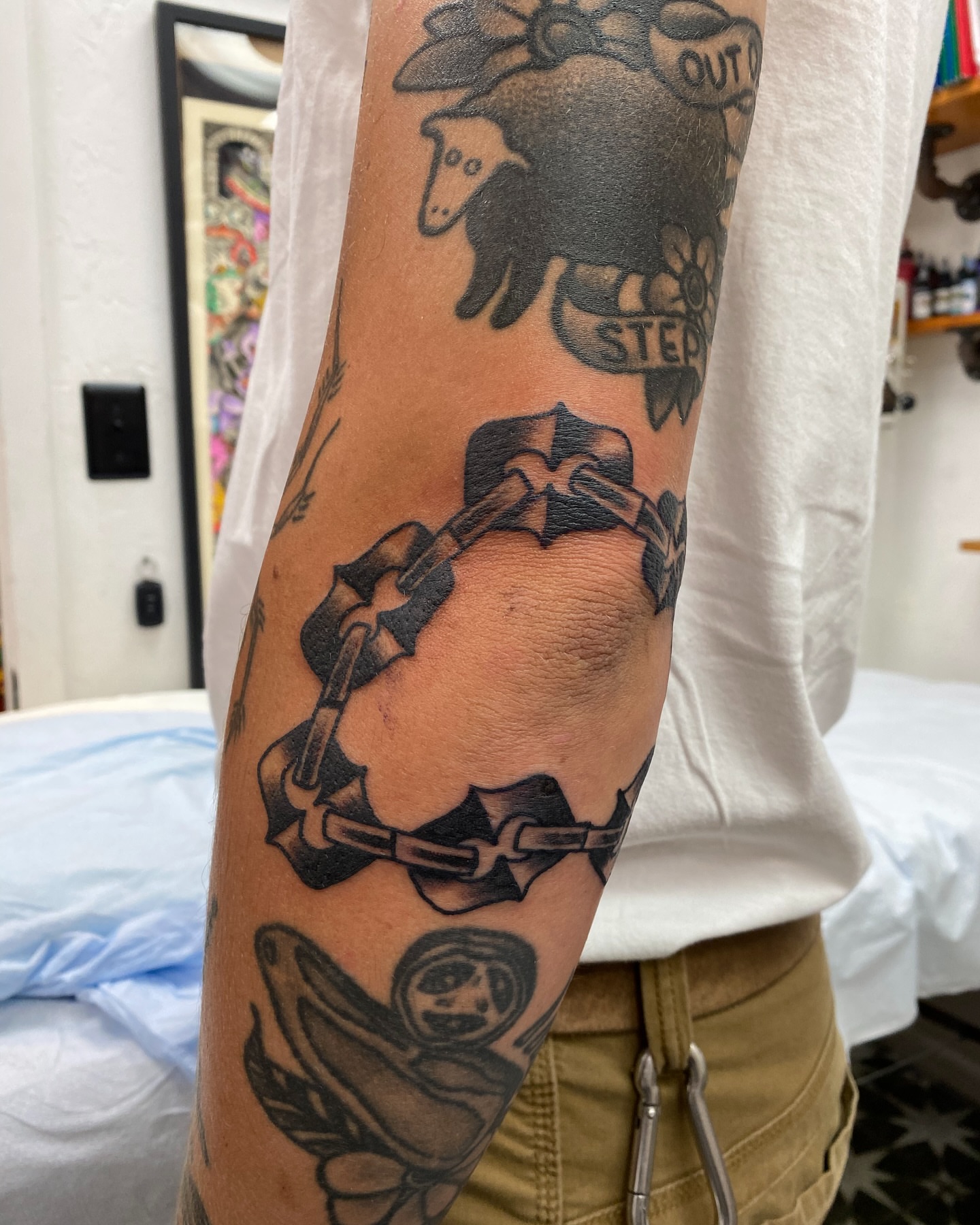 Chains American traditional tattoo on the forearm by Mike Tapia