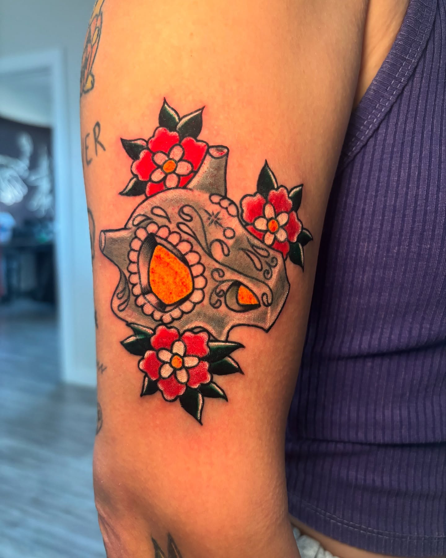 Sugar skull with flowers American traditional tattoo on the forearm by Eric Garcia