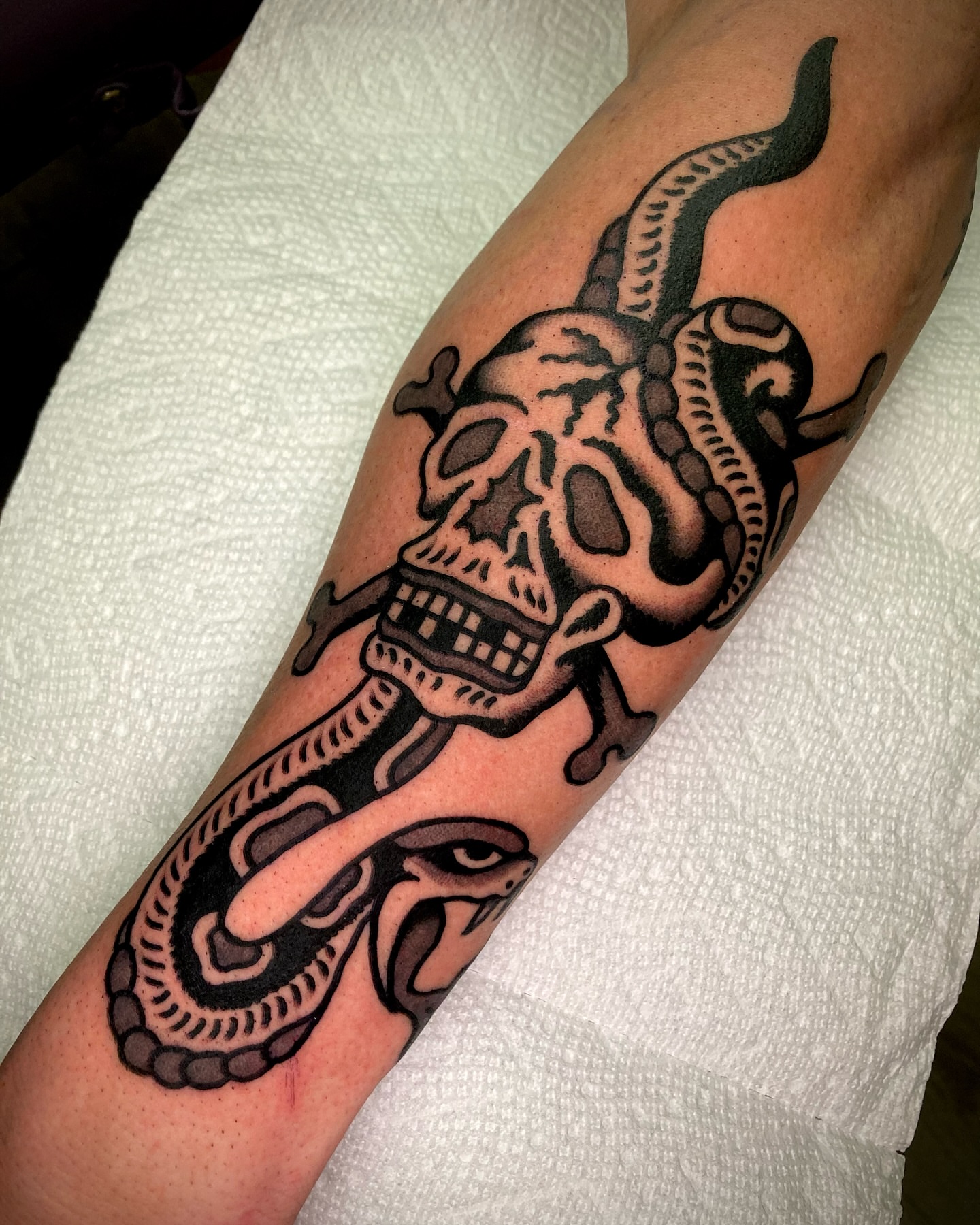 Skull and snake American traditional tattoo on the forearm by π΅ππππ π¬ππππ